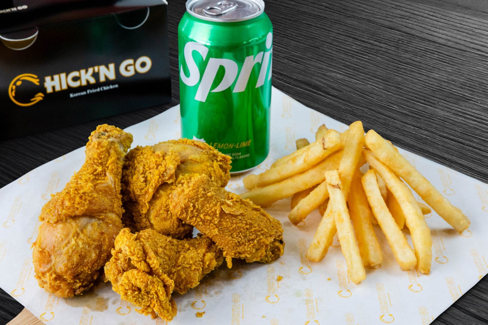 A plate of fried chicken and french fries with a drink.