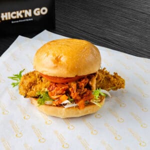 A chicken sandwich sitting on top of a bun.