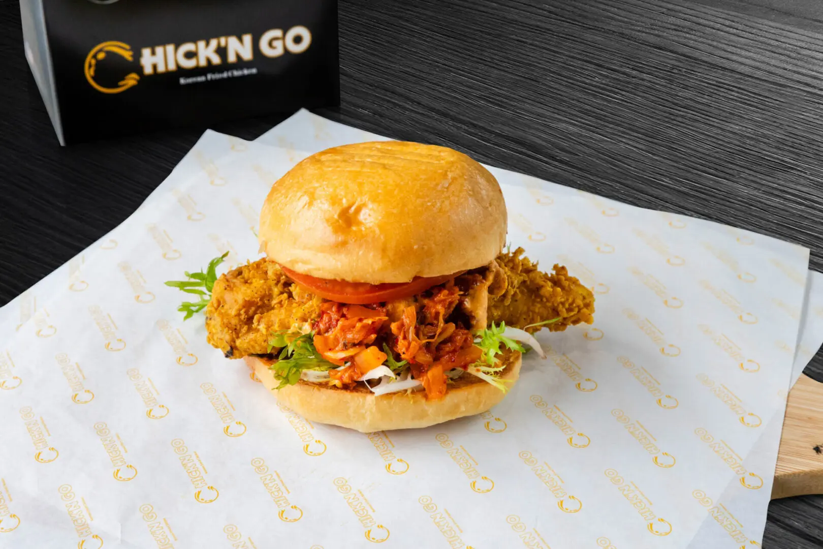 A chicken sandwich sitting on top of a bun.