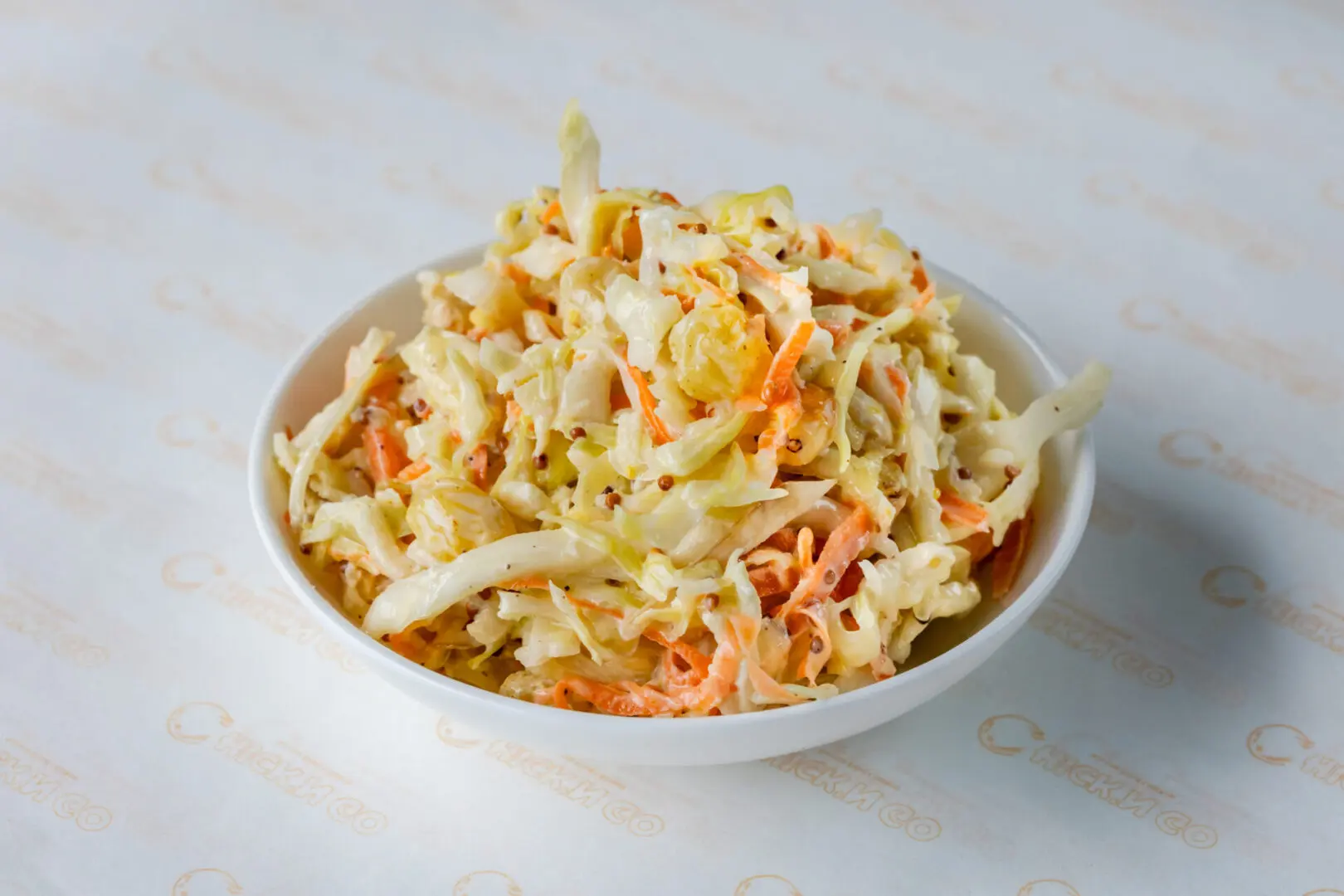 A bowl of coleslaw on the table