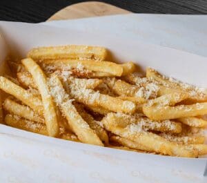 A close up of some french fries in a paper container