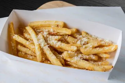 A close up of some french fries in a paper container