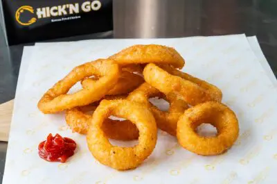 A close up of some onion rings on a plate